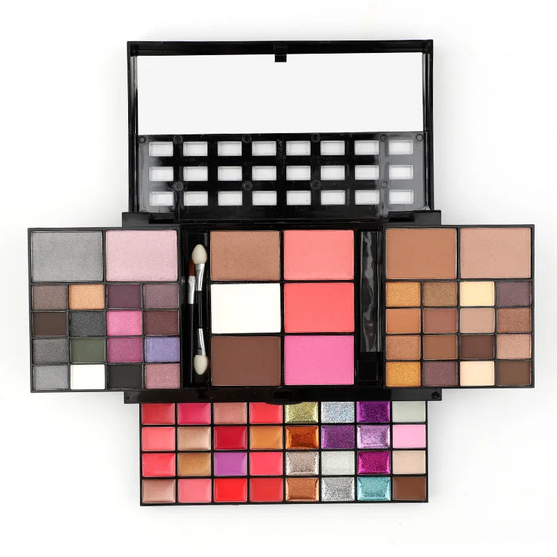 74 colour makeup palette open showing layered powder plates with eyeshadows, lip glosses, blush and contour, with mirror and brushes.