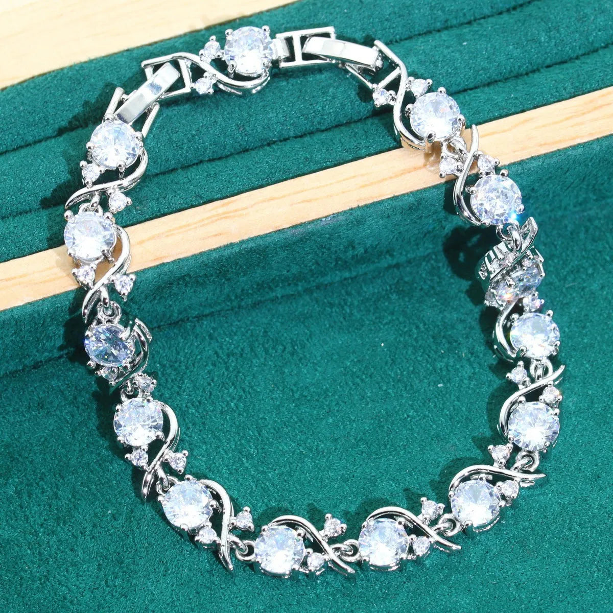 Bridal zircon four-piece jewellery set showing necklace, bracelet, earrings and ring in alloy with water wave chain