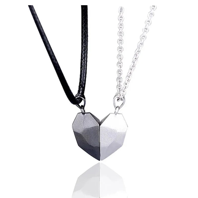 Gold-plated magnetic faceted heart pendant necklace in black and white on display