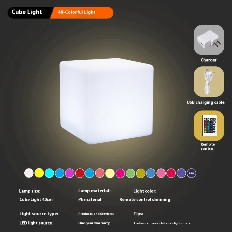 Square LED cube stool light in garden setting showing modern design with lighting