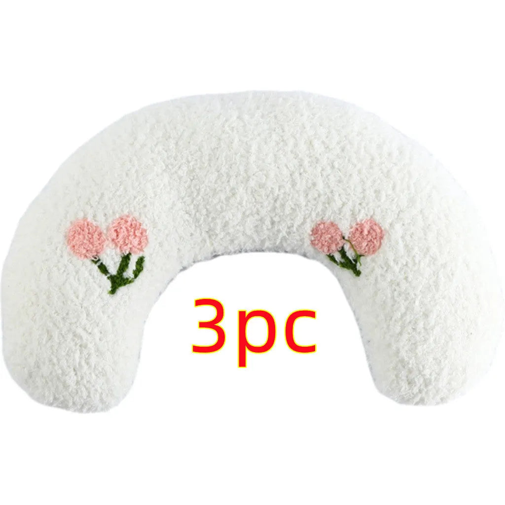 White U-shaped plush pet pillow for a cat, showing its donut shape and quilted texture.