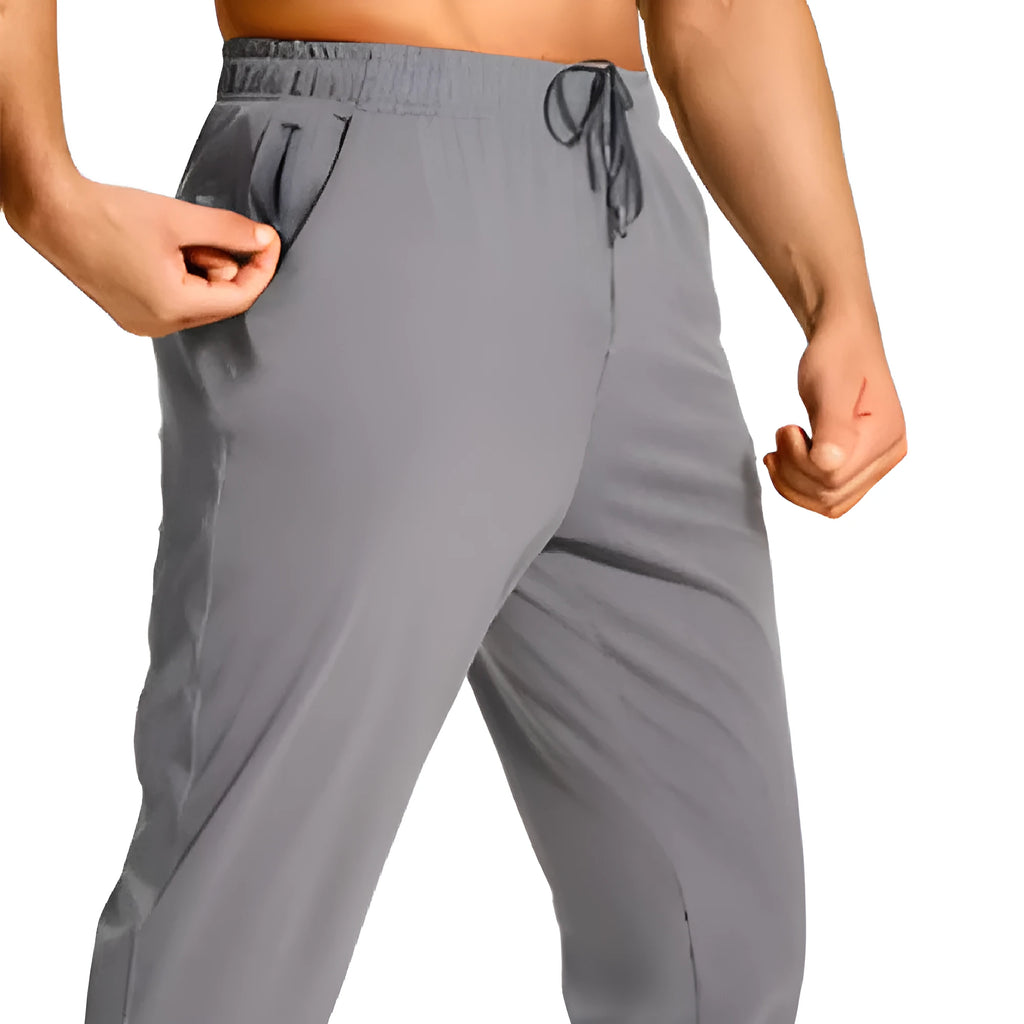Men's solid colour loose fit casual trousers in polyester fabric on a hanger.
