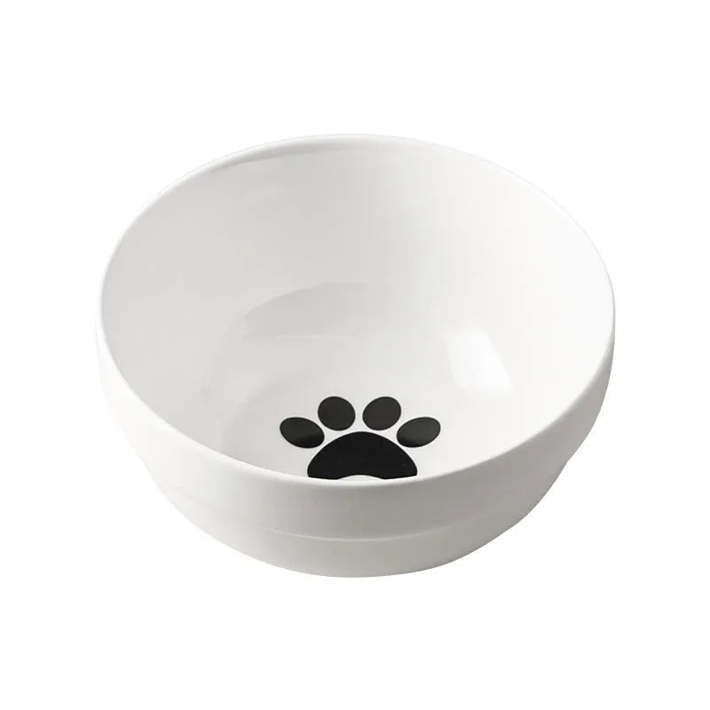 White ceramic cat bowl with paw print design in a black iron cat-ear frame.