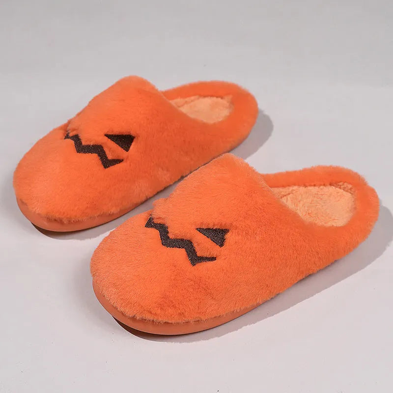 Orange Halloween pumpkin slippers with plush lining and a textured non-slip PVC sole.