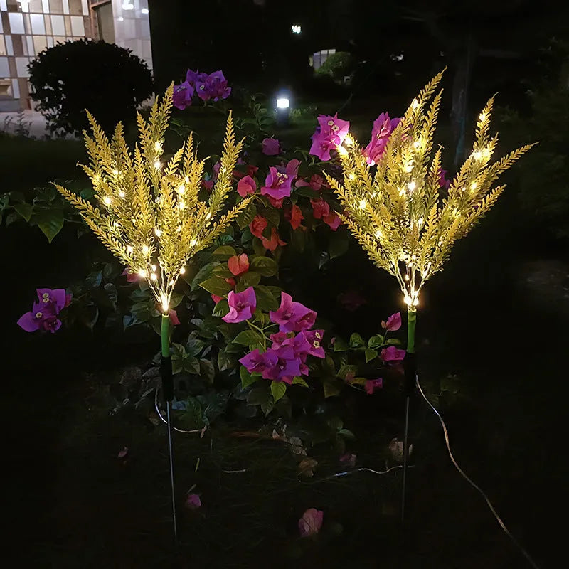 74cm tall solar-powered lavender-shaped LED garden light with stainless steel stem in a flower bed.