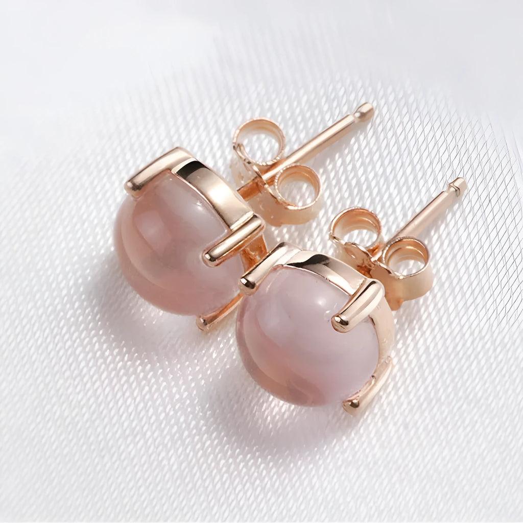 Rose gold plated drop shape stud earrings with a synthetic quartz crystal inlay detail.