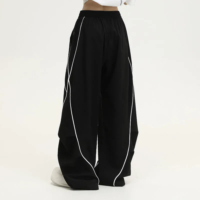 Black pleated wide-leg hip hop trousers with stripes, loose fit for sports.