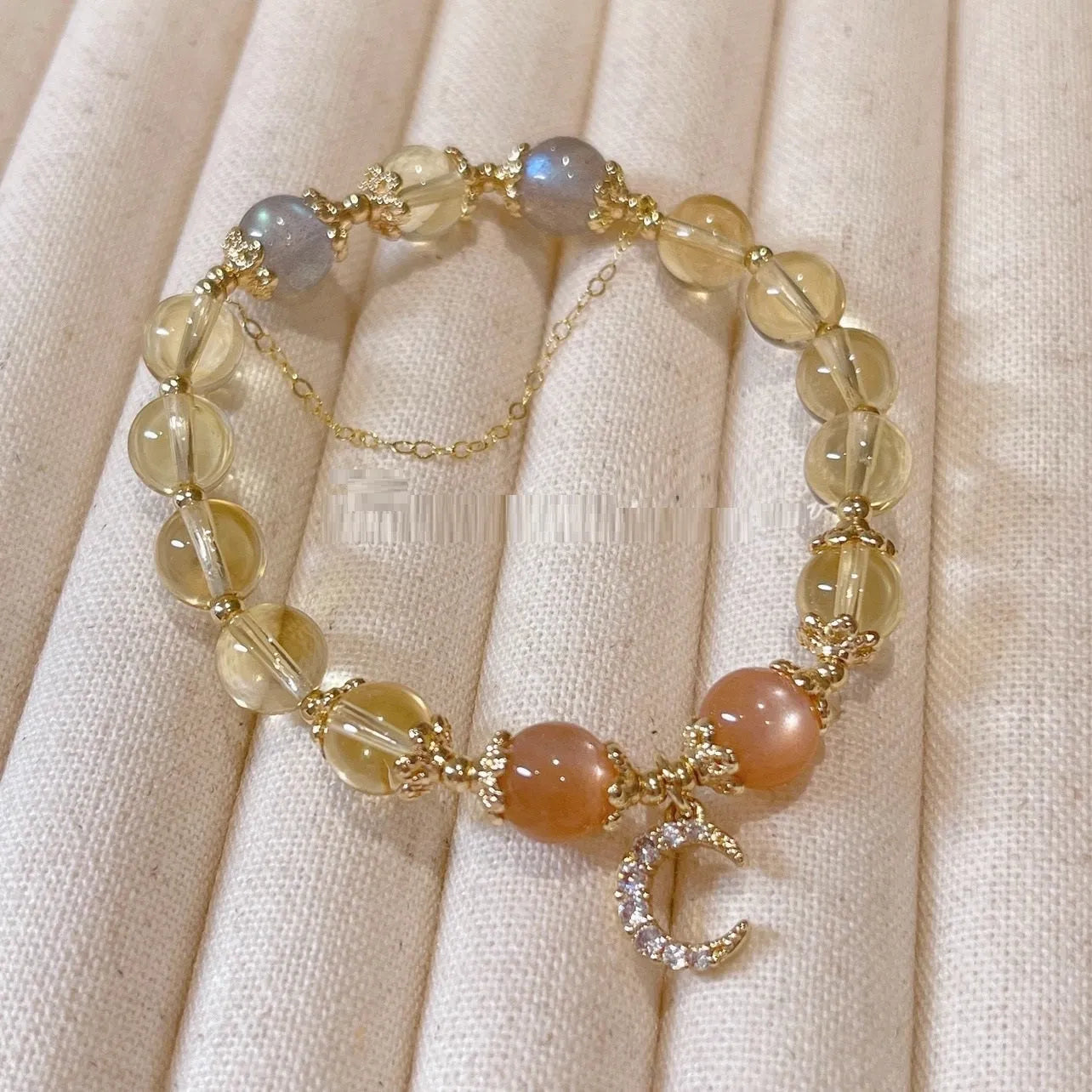 Moonstone crystal bracelet with 14K gold electroplating and diamond-shaped citrine beads on adjustable band