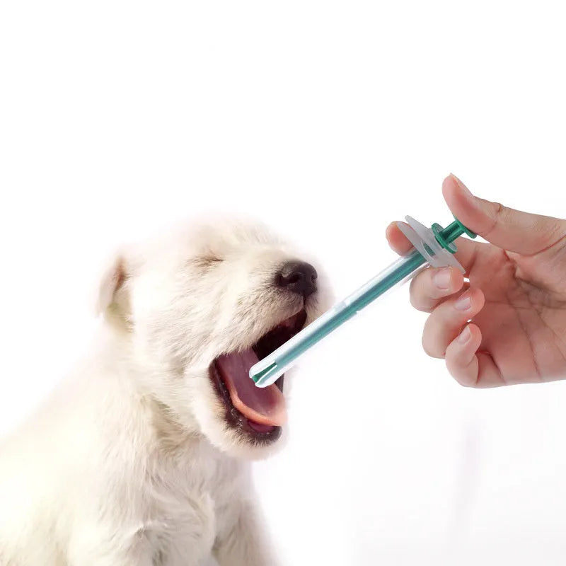 Two pet pill shooter syringes with soft tips, one larger and one smaller, for administering medication to cats and dogs.