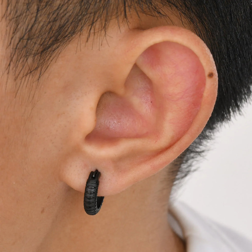 A pair of stainless steel hip hop ear rings with a snake pattern design in a black finish.