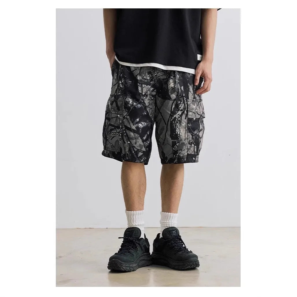 Loose fit straight-leg denim shorts in black or army green on a hanger, showing mid-waist and zip fly detail.