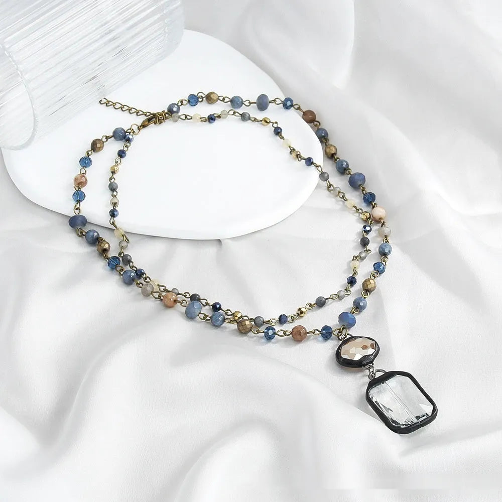 Adjustable tribal necklace with glass and stone pendant on two-layer chain in beige colour