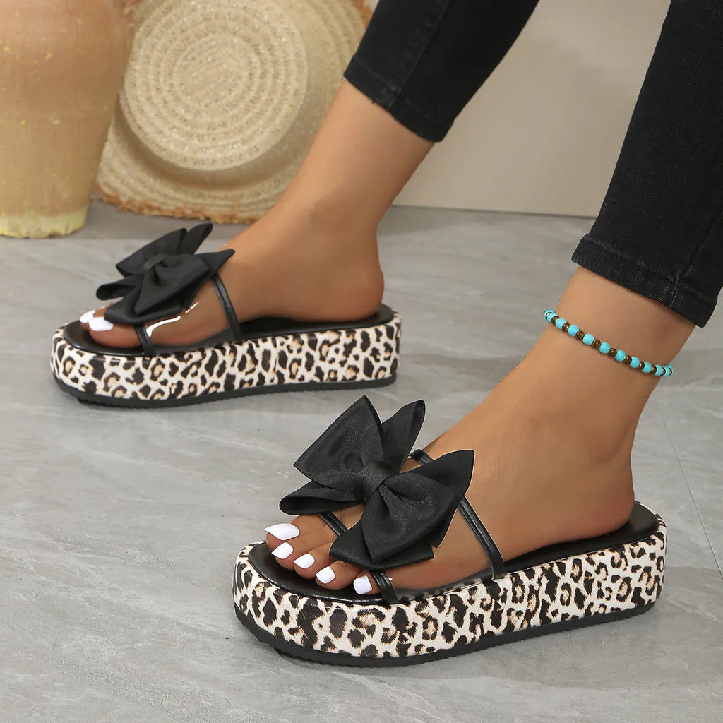 Women's leopard print beach slippers with thick rubber sole and round-toe design in black and white