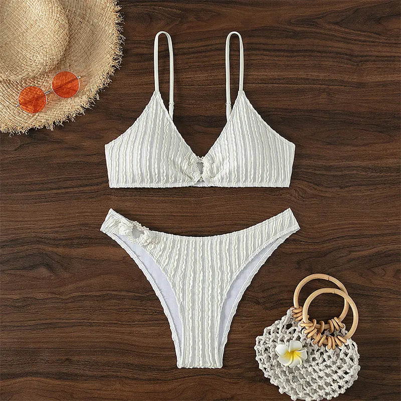 White women's V-neck sleeveless swimsuit top with matching shorts on a mannequin.