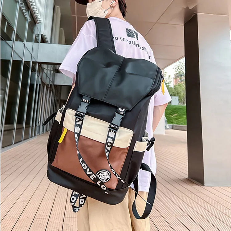 Oxford cloth school backpack in black, green, or red colour options.
