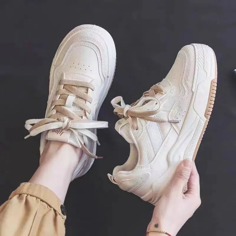 Women's pink low-top sneakers with imitation leather upper and rubber sole for hidden height increase.