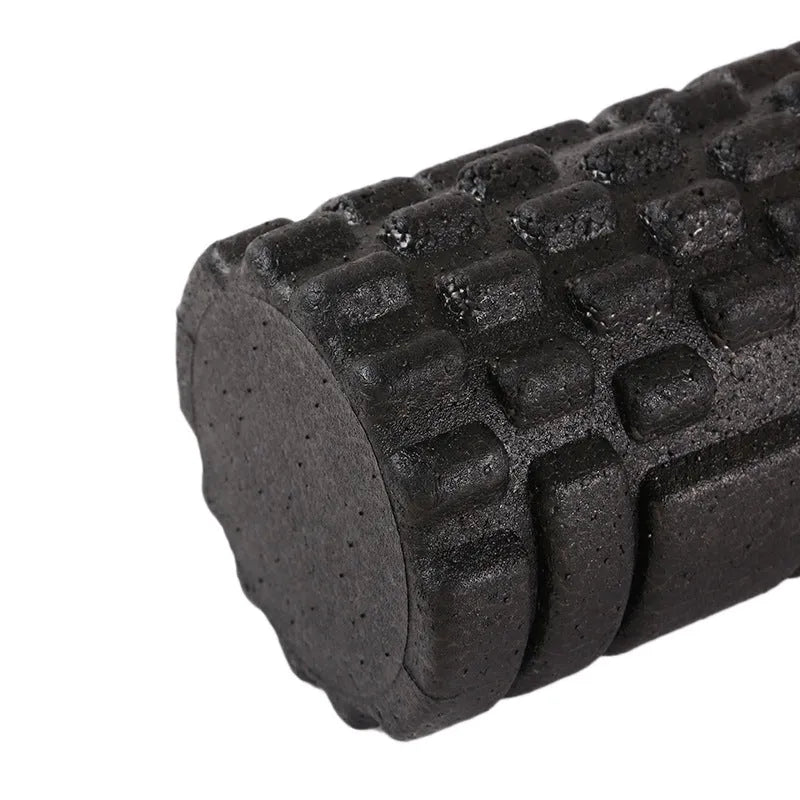 Hollow black EPP foam roller 33x14cm on a white background for Pilates and balance exercises