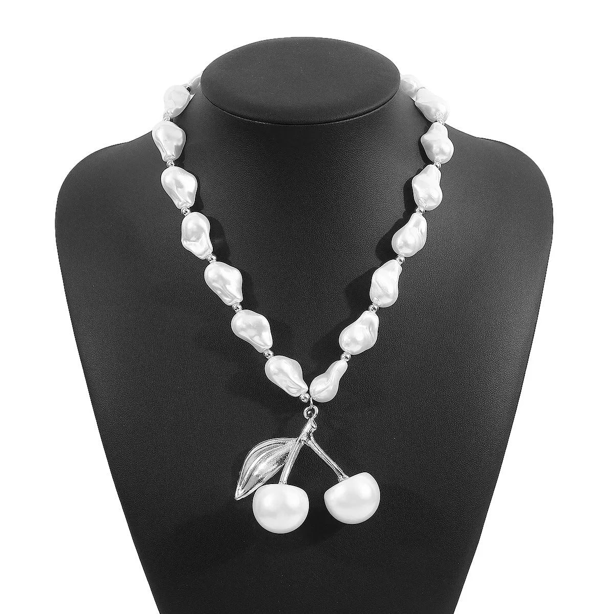 Gold coloured alloy cherry fruit pendant on an adjustable imitation pearl necklace for women.