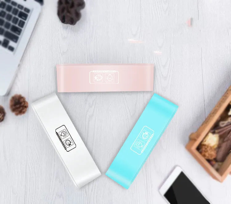 Blue rectangular LED atmosphere light alarm clock with digital display on a table.