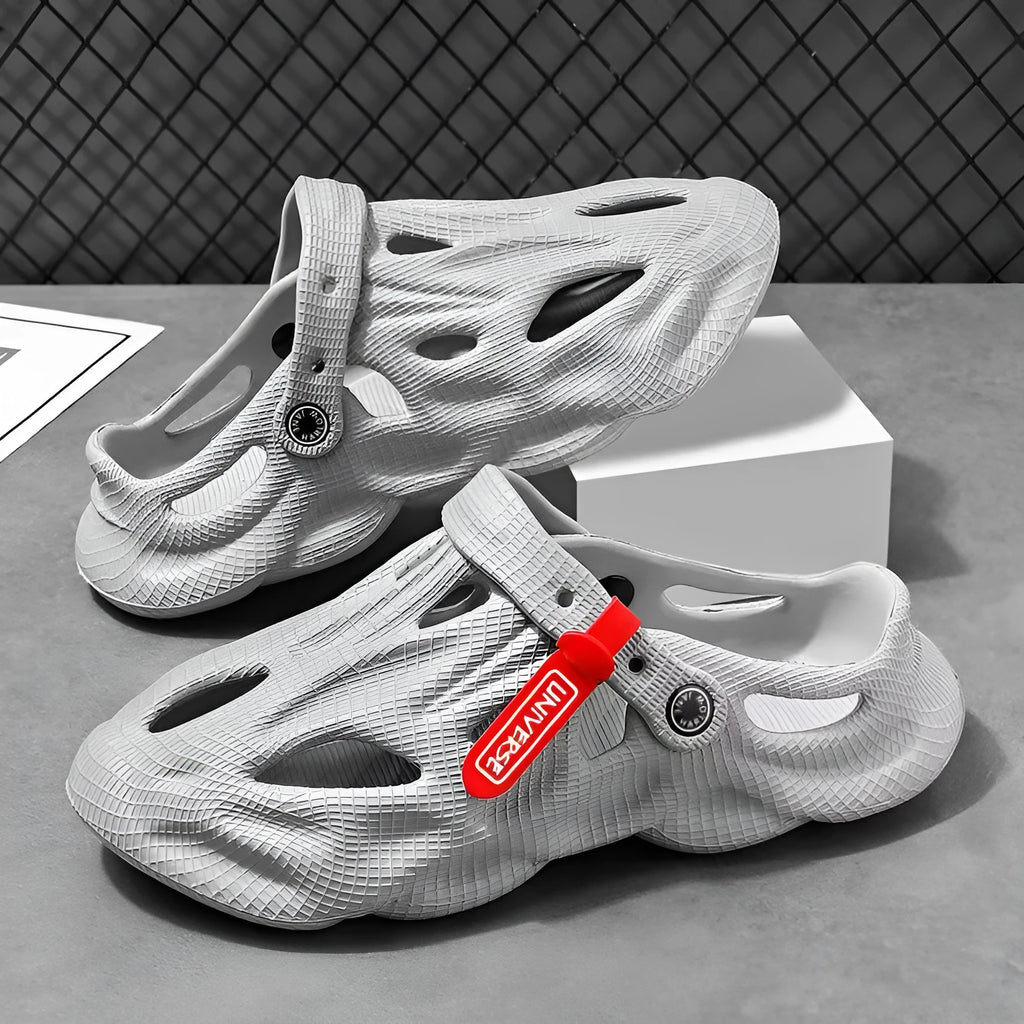 Pair of solid grey closed-toe EVA coconut slippers on a white background.