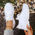 Women's low-top breathable mesh sports shoes in beige with lace-up front and platform sole.