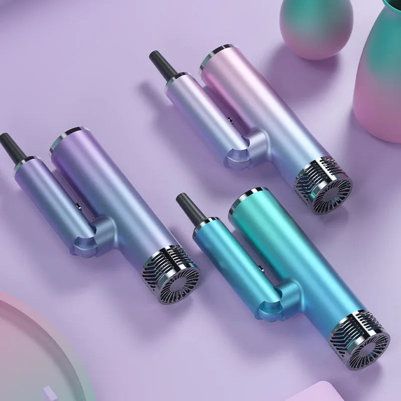 Green foldable hair dryer with collapsed handle next to suitcase showing its compact travel size