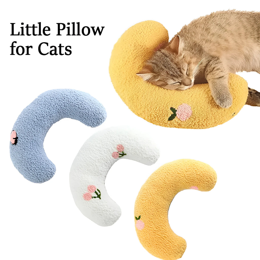 Plush white U-shaped pet pillow with raised rim for a cat or small dog to sleep curled up.