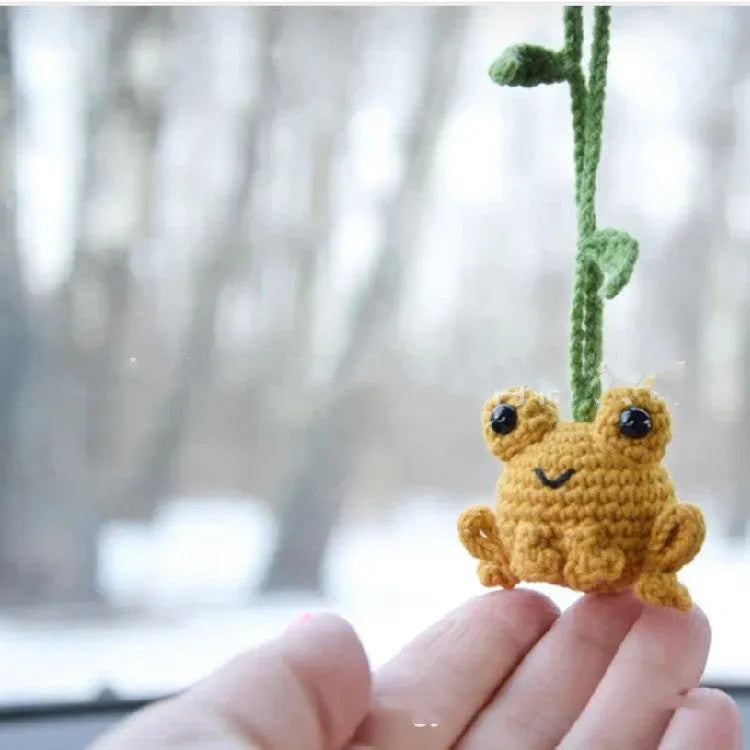 Handmade green plush frog car pendant hanging, showing woven texture and 15cm length