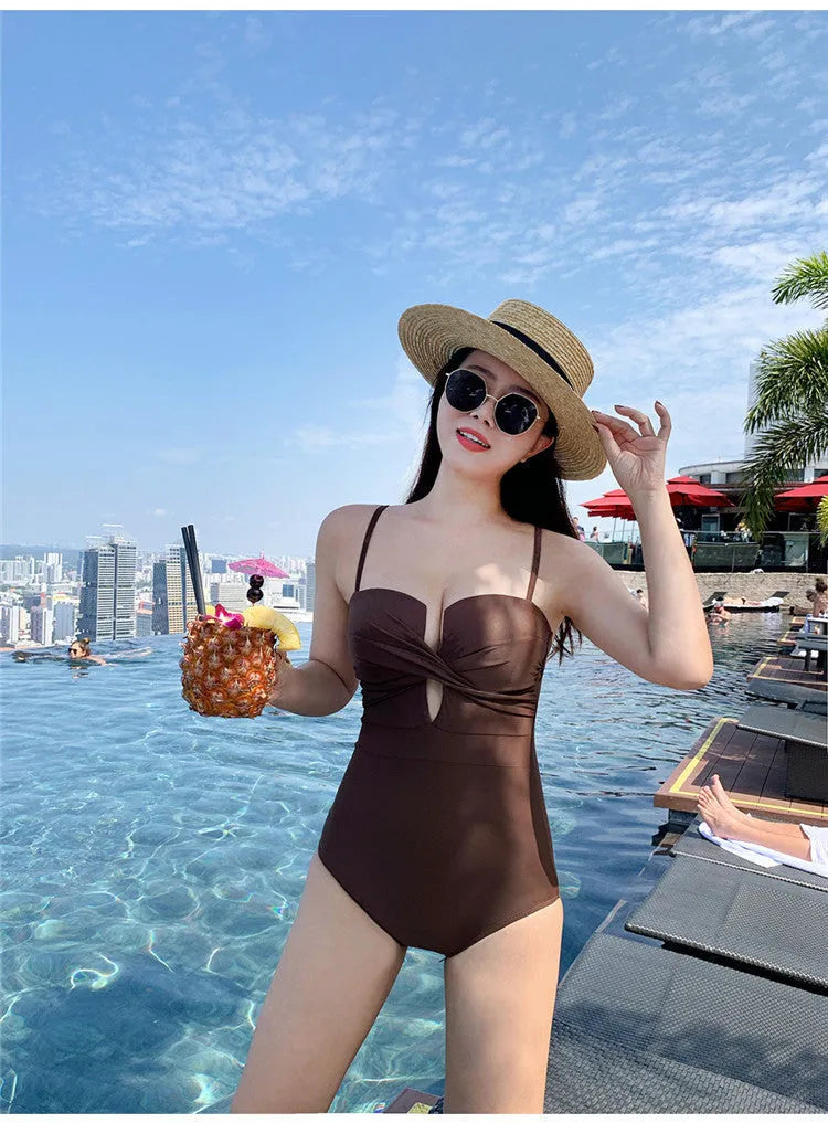 Solid colour one-piece swimsuit with spaghetti straps and push-up design in white, pink or brown