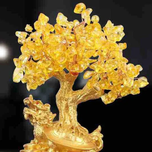 Citrine-coloured resin Feng Shui ornament of a water turtle with a money tree.