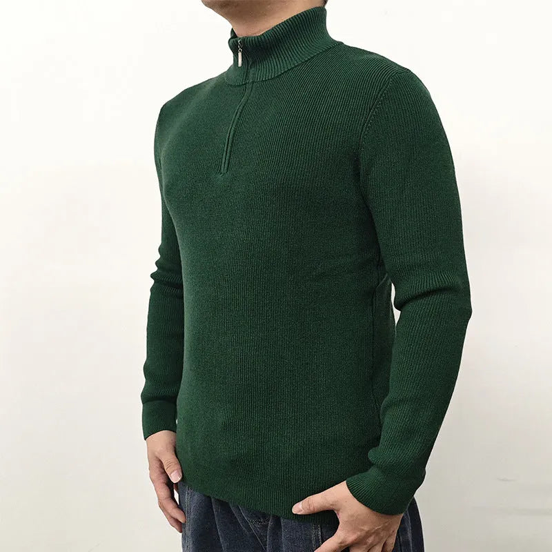 Men's black half-turtleneck zip sweater with long sleeves, shown on a model.