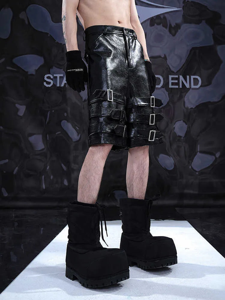 Men's black PU leather casual cropped shorts on a hanger.