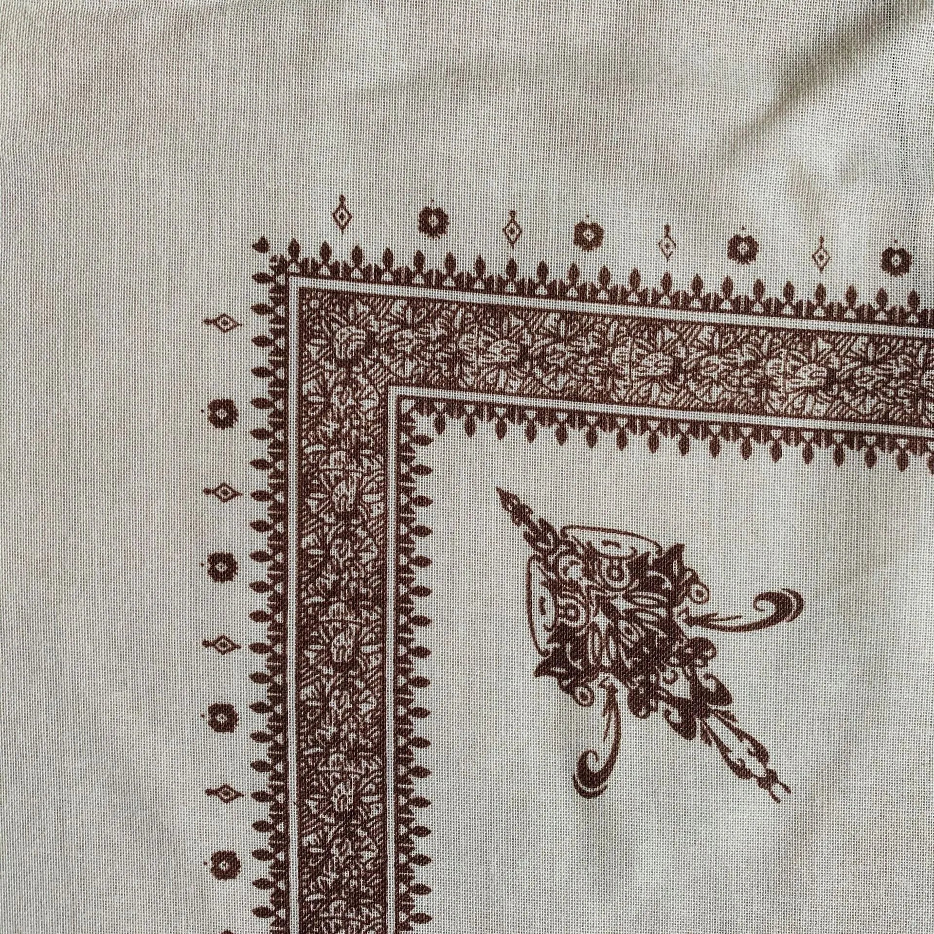 A large brown printed square polyester scarf laid flat, showing its 138x138 cm size.
