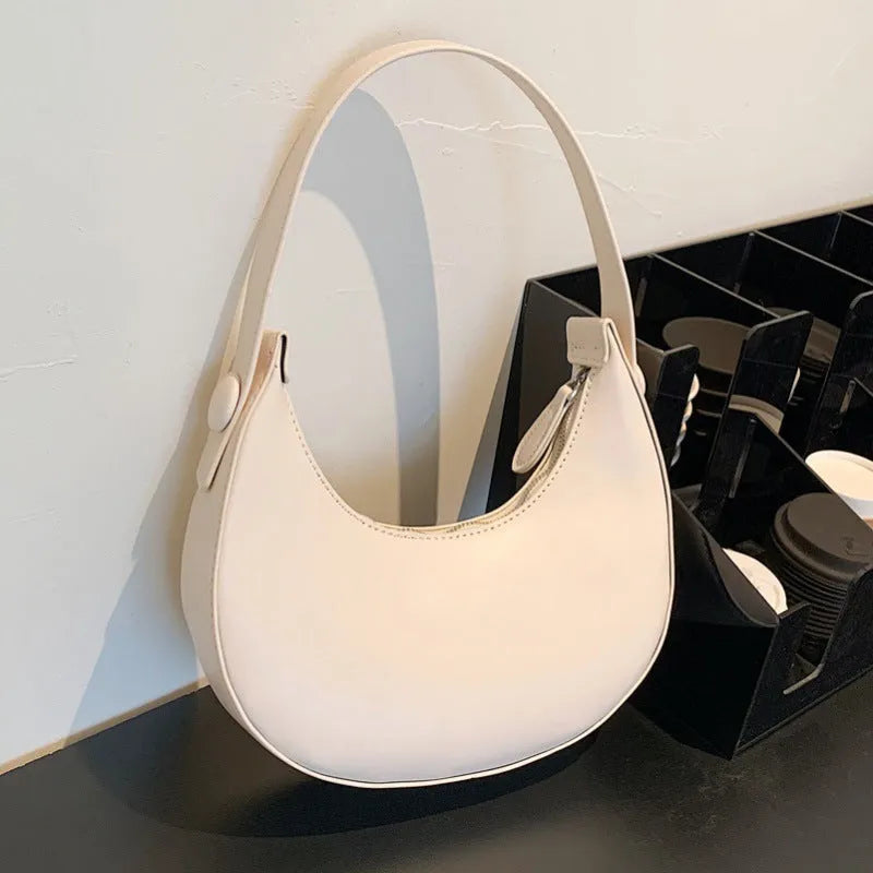 Retro dumpling-shaped women's shoulder bag in PU leather with a zippered pocket.