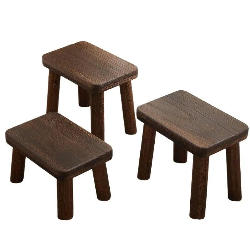 Solid wood distressed finish changing stool with bracket structure legs.