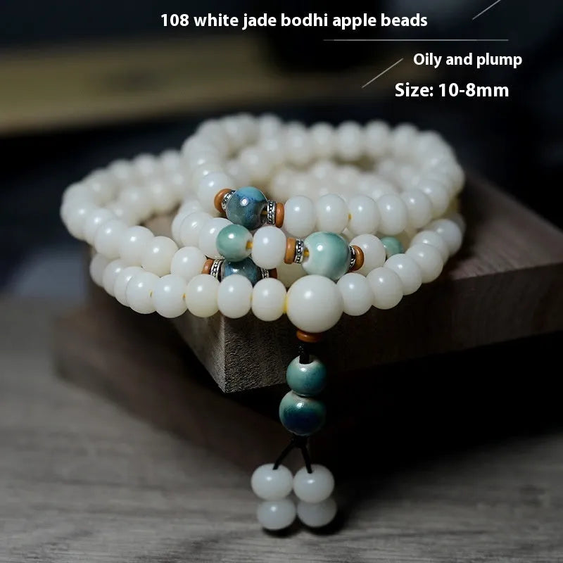 White Jade Bodhi Root Oblate Bead Bracelet with 108 flat round beads on a wrist.