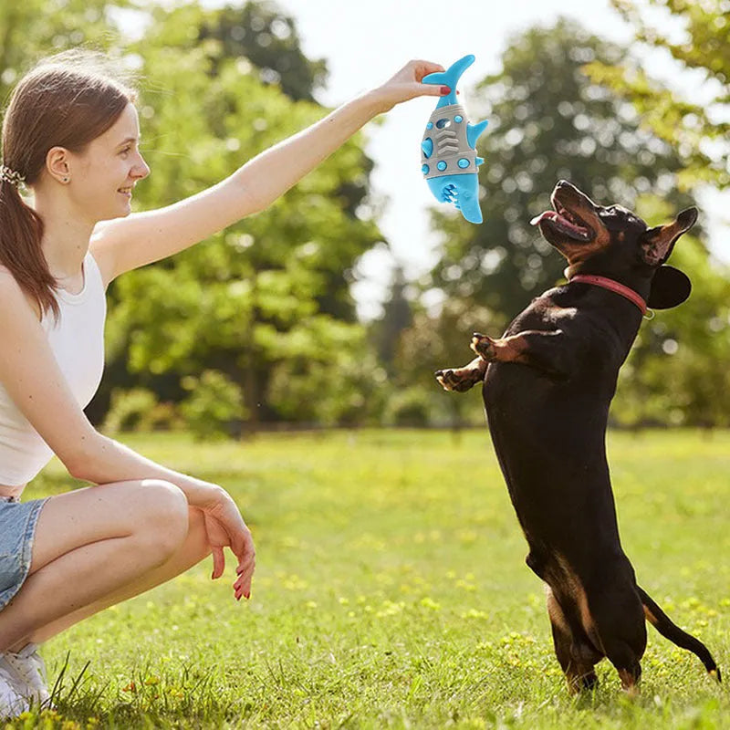 Blue rubber dog chew toy with shark-tooth texture and venting channels for teething puppies