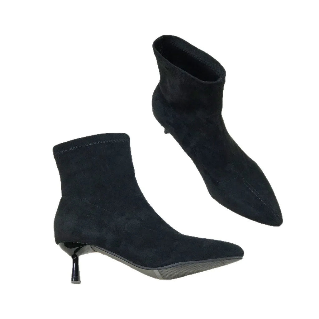 Women's black pointed toe ankle boots with a stiletto heel on a rubber sole.