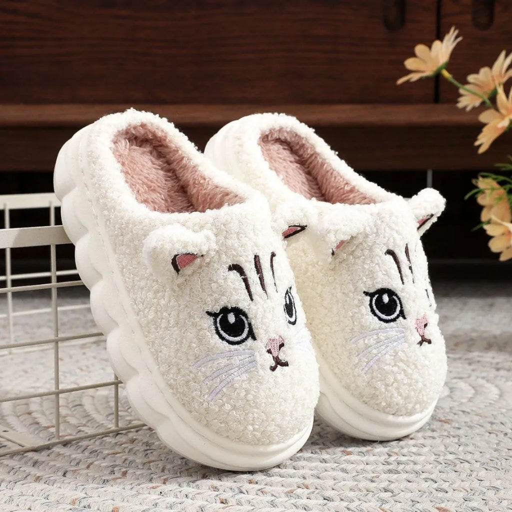 Winter cartoon cat fluffy slippers with plush upper and non-slip EVA sole, in black, white, pink, or grey.