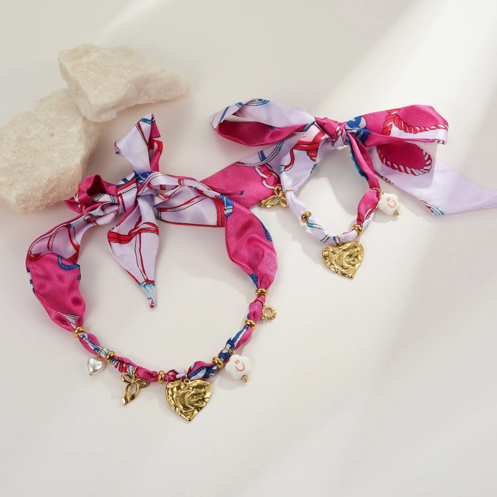 Stainless steel necklace and bracelet set with geometric pendant and gold electroplated finish.