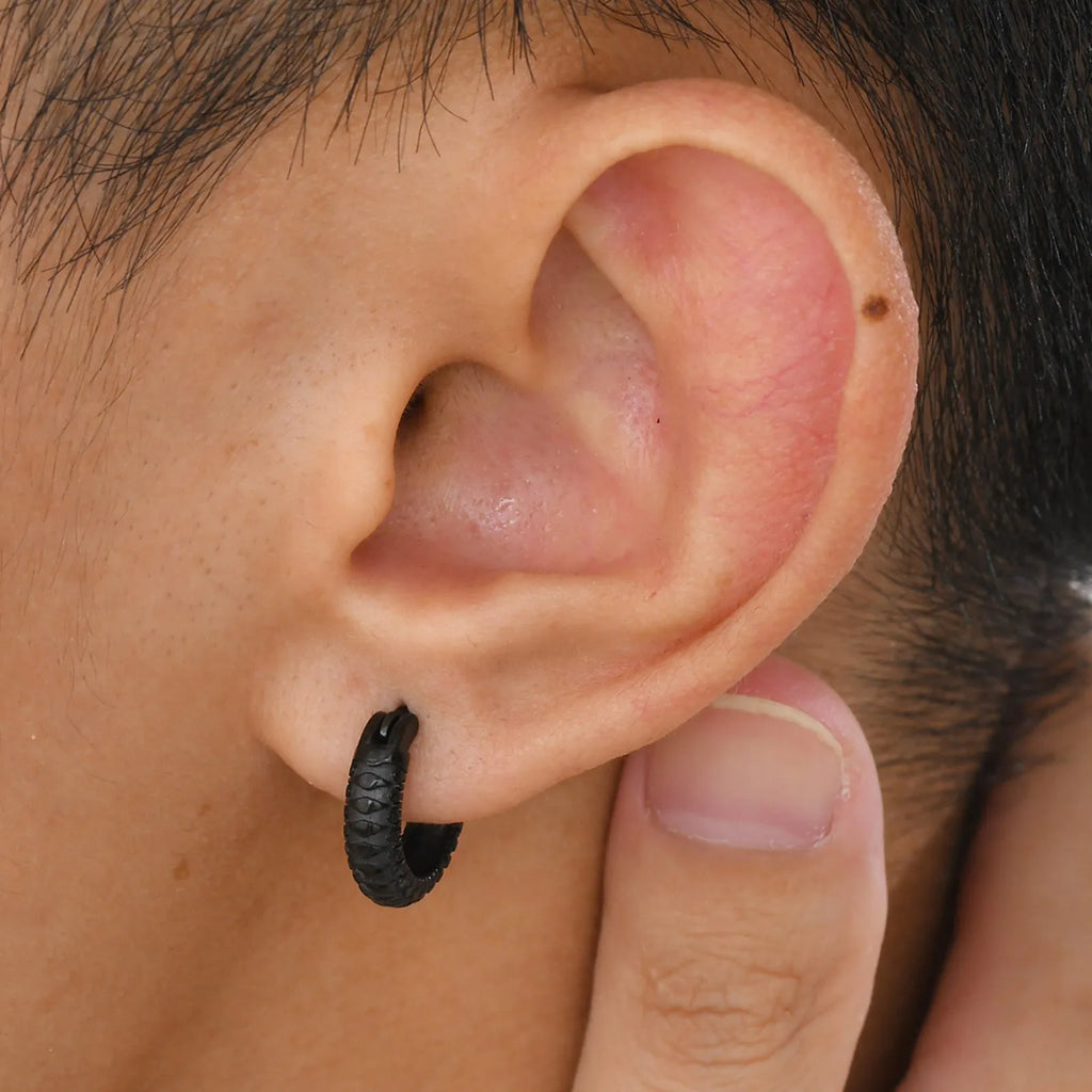 A pair of stainless steel hip hop ear rings with a snake pattern design in a black finish.