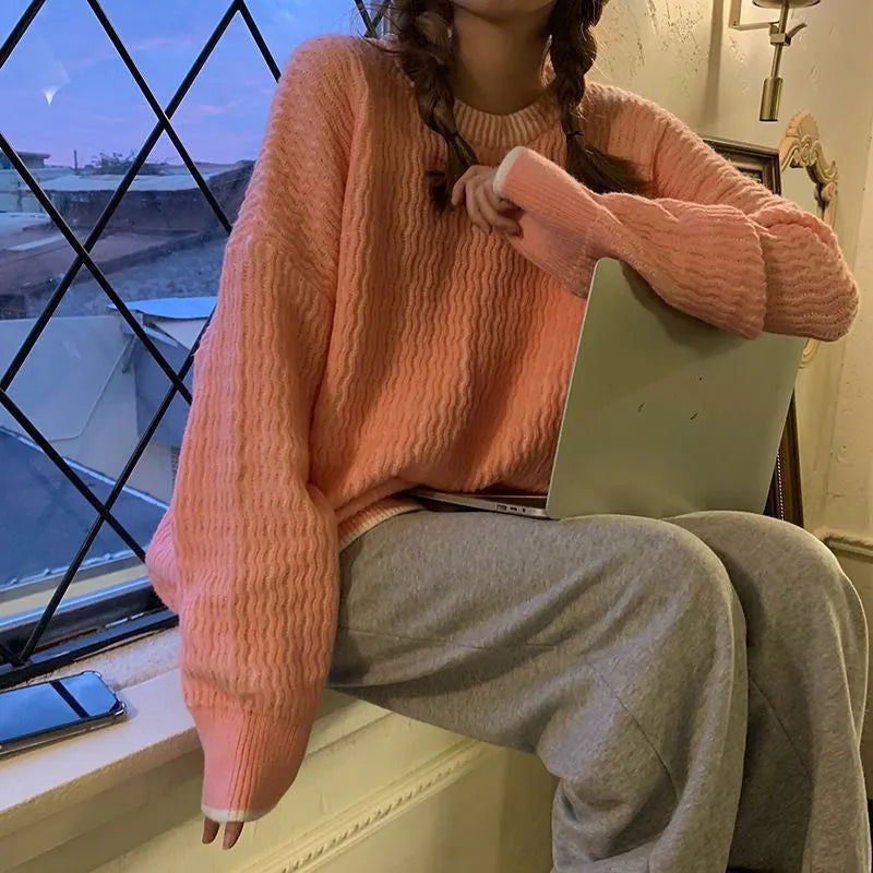 A loose-fitting women's pullover sweater in a solid colour, shown in a lake blue hue with long sleeves.