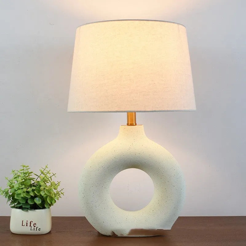 Feng pottery pot table lamp in Japanese style on a wooden desk.