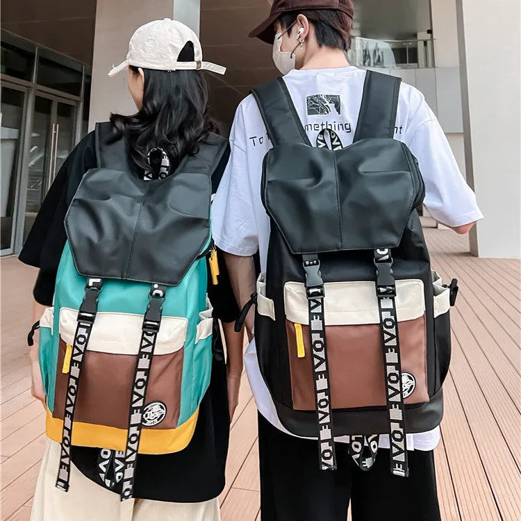 Oxford cloth school backpack in black, green, or red colour options.