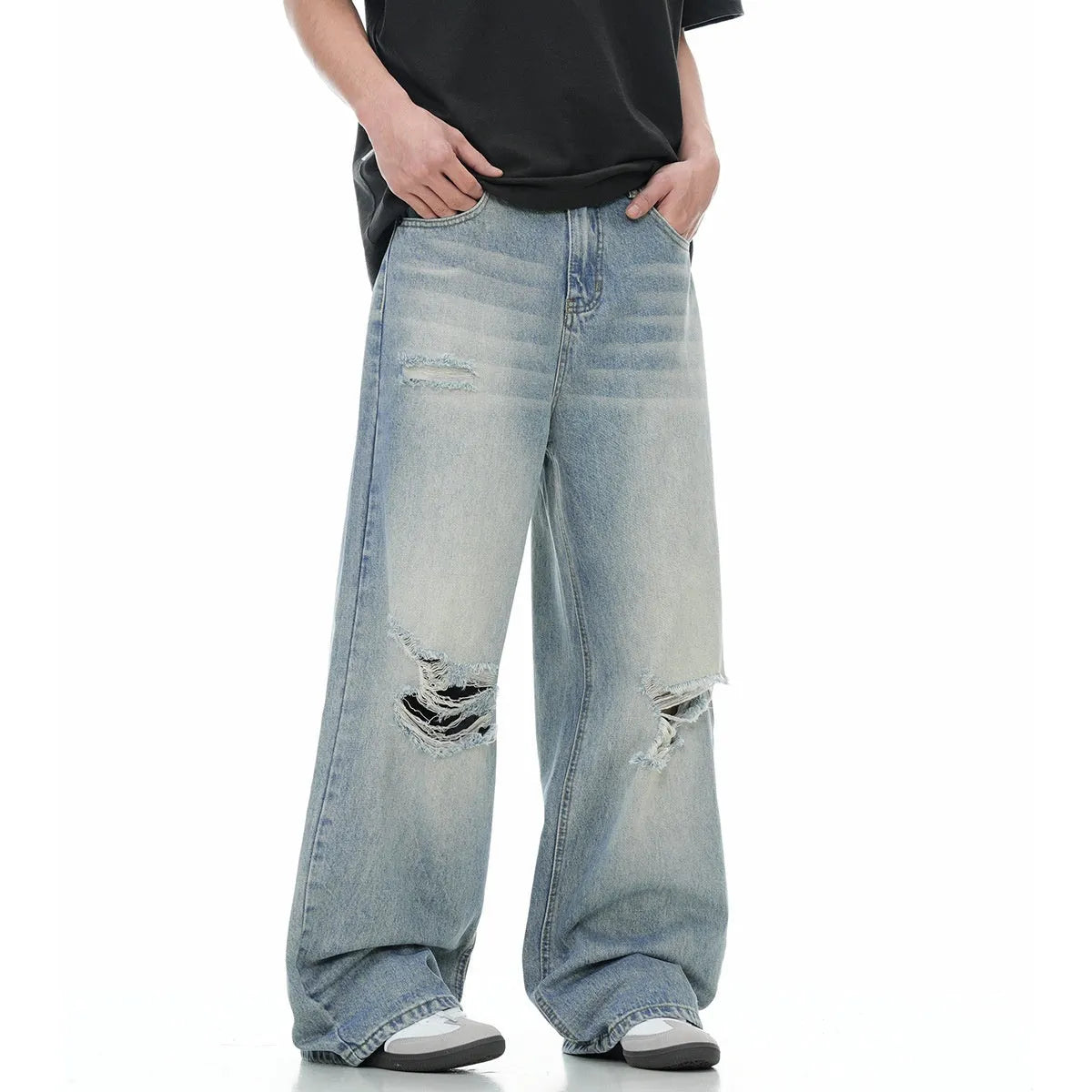 Men's blue distressed straight-leg retro jeans with a zip fly on a plain background.