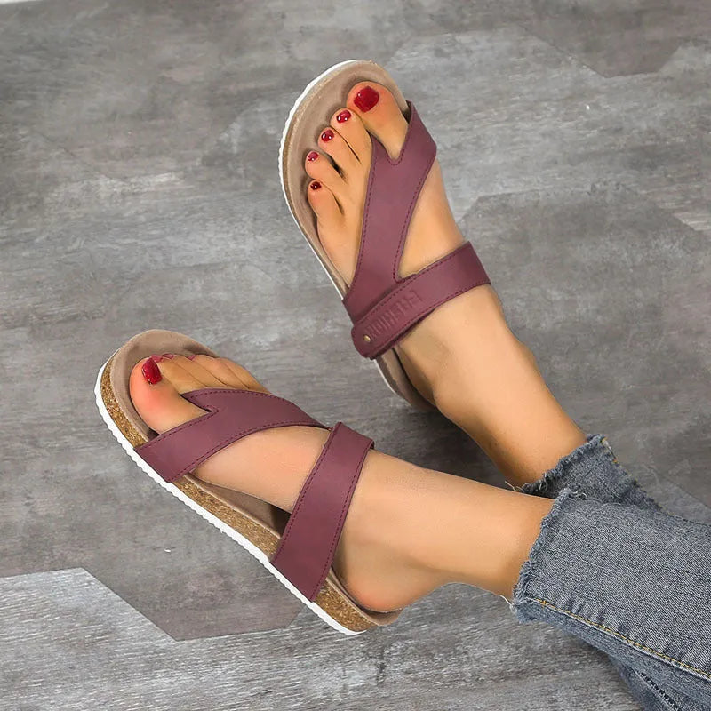 A pair of thick-soled flat toe ring flip flops in a solid colour, showing the foam sole and artificial PU upper.