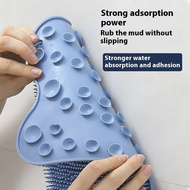 Blue silicone bath scrub mat for back washing, measuring 31cm by 32cm, mounted on a shower wall.