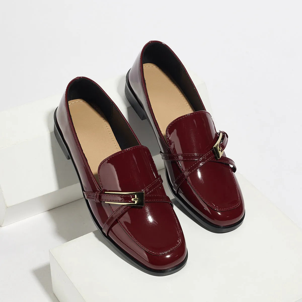 Patent leather square toe loafers in black with low heel and rubber sole