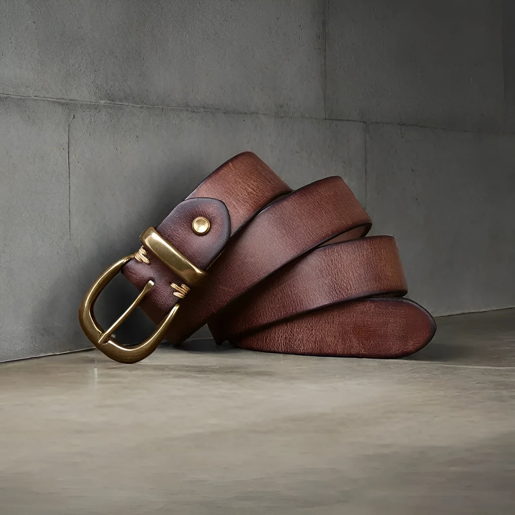Men's brown cowhide leather casual belt with copper pin buckle on a flat surface