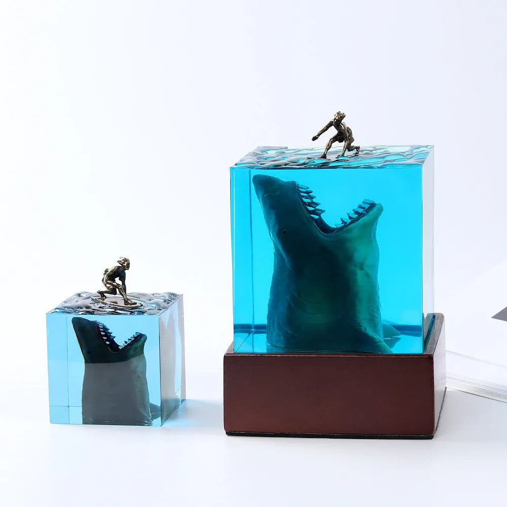Clear epoxy resin shark surfer night light ornament with LED base in 5cm and 8cm sizes.